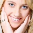 Studio portrait of a long blond girl smiling