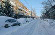 Cars covered by snow on the street