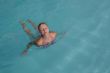 Beautiful young woman in the pool