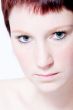 Studio portrait of a young woman with short hair making eye cont