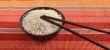 Raw rice in a bowl with sticks