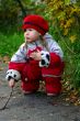 Little girl sitting in the fall park