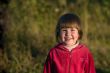 Laughing girl in sunset lights in the grass