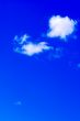 Couple of clouds in vivid blue sky