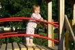Toddler standing on playground in sunset lights