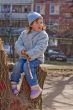 Kid sitting on stump