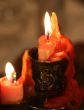 red candle flaming upon dark background
