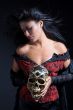 Beautiful brazilian woman holding a skull