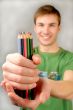  multi-coloured pencils in hands