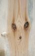 Knots on textured wooden plank like alien face