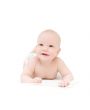 Funny little baby lying on white bed