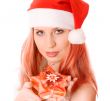 Winter portrait of a beautiful smiling woman with a gift