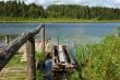 Forest lake with fishing boat at berth