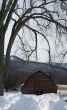 old red snowed in barn