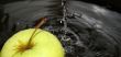 Green apple in dark water