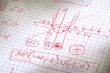 hand written maths calculations in red