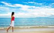 red dress girl strolling on the beach