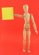 figure holding empty adhesive note