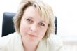 Mid-life business woman in office look at camera