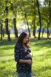 Pleasured pregnant woman in blue jeans do daily promenade