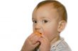 baby boy eatng orange