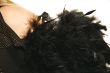 women`s shoulder with black feather boa