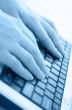 Typing on a laptop