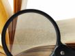 book with magnifying glass