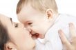 happy mother kissing baby boy