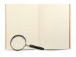 exercise book and magnifying glass