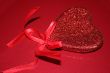 Red hearts on red background