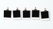 Five polaroid blanks on a wall 3D