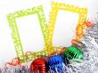 two photoframes with decorative balls and tinsel