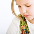 Head shot of a blond young girl looking down