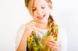 Young girl having fun painting eggs for easter