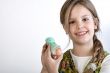 Young girl with painted egg with hat