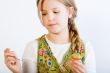 Young girl with painting brush and egg