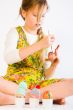 Young girl painting easter eggs