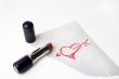 Heart drawn by lipstick on a paper