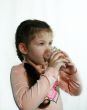 The little girl drinks milk