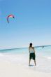 girl looking at kite surfer in the sea