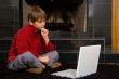 Boy at Fireplace on Computer