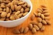 Bowl of almonds on rattan mat