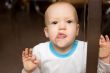Spellbound baby cling by tongue to the shopwindow