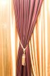 Purple velvet courtain with golden tassel