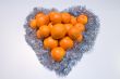 Heart made of citrus fruits. Present.