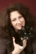 Portrait of the young smiling woman with a cat.