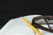 Pencil and glasses on a book