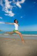 jumping joyfully at the beach