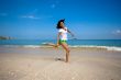 jumping joyfully at the beach